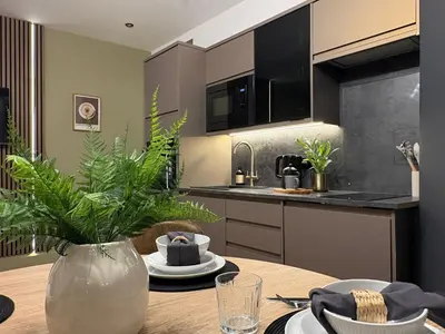 a kitchen with a wooden table with a vase on it at ArtBnB Apartment Two in Blackpool