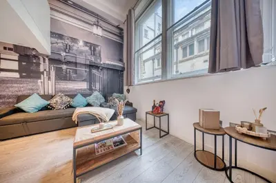 a living room with a couch and a table at Premium Central Liverpool Apartment in Liverpool