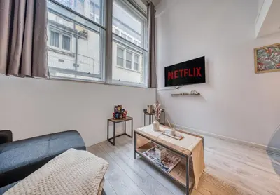 a living room with a couch and a window at Premium Central Liverpool Apartment in Liverpool