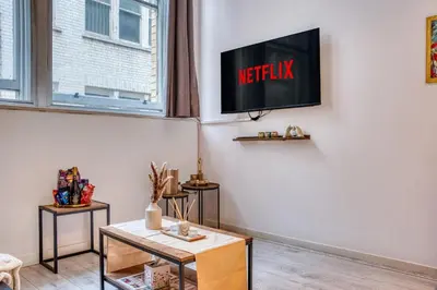 a living room with a tv on the wall at Premium Central Liverpool Apartment in Liverpool