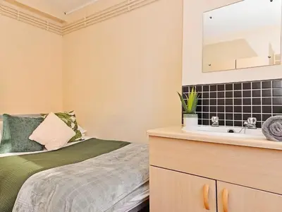 a bedroom with a bed and a sink at For Students Only St Andrews Gardens in Liverpool in Liverpool