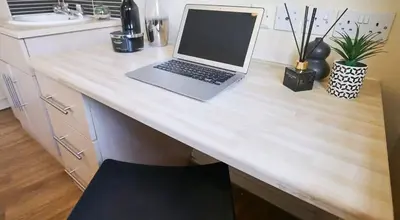 a laptop computer sitting on top of a wooden desk at For Students Only St Andrews Gardens in Liverpool in Liverpool