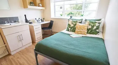 a small bedroom with a bed and a sink at For Students Only St Andrews Gardens in Liverpool in Liverpool