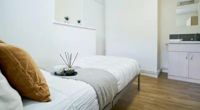 a white room with a bed and a kitchen at For Students Only St Andrews Gardens in Liverpool in Liverpool