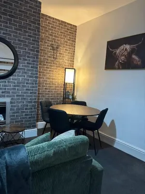 a living room with a table and chairs and a couch at Farm Street House by Sapphire Properties -Near to BAE Systems in Barrow