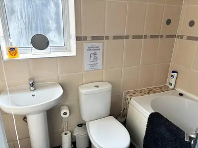 a small bathroom with a toilet and a sink at Farm Street House by Sapphire Properties -Near to BAE Systems in Barrow