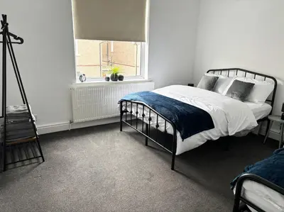a white bedroom with a bed and a window at Farm Street House by Sapphire Properties -Near to BAE Systems in Barrow