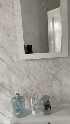 a bathroom sink with a mirror and a toothbrush at My House in Bolton