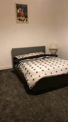 a bed with polka dots on it in a bedroom at My House in Bolton