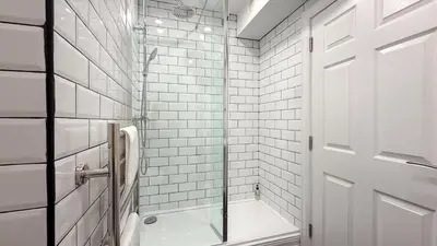 a bathroom with a shower and a glass door at Hamilton Square Gardens Apartments by Rework Accommodation in Birkenhead