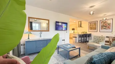 a living room with a couch and a table at Hamilton Square Gardens Apartments by Rework Accommodation in Birkenhead