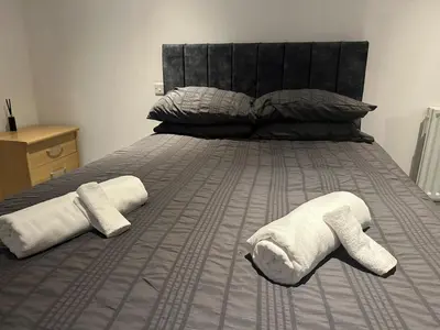 a bedroom with a bed with two towels on it at Modern Central Flat - Business and Leisure Stays in Preston