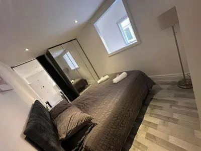 a bedroom with a large bed with a large mirror at Modern Central Flat - Business and Leisure Stays in Preston