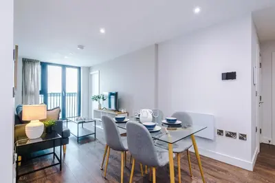 a living room with a dining room table and chairs at Luxury River Mersey Retreat in Central Liverpool in Liverpool