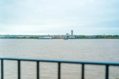 a large body of water with a city in the background at Luxury River Mersey Retreat in Central Liverpool in Liverpool