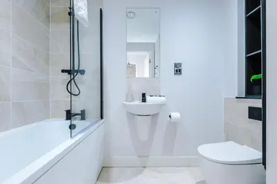 a white bathroom with a toilet and a sink at Luxury River Mersey Retreat in Central Liverpool in Liverpool