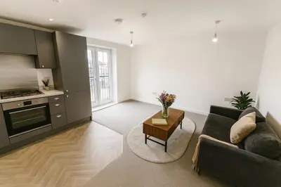 a living room with a couch and a table at Modern One Bedroom Flat near Anfield Stadium with Parking in Liverpool