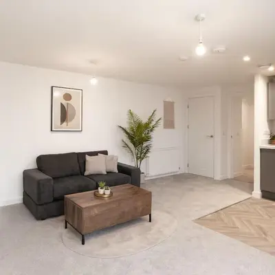 a living room with a couch and a coffee table at Modern One Bedroom Flat near Anfield Stadium with Parking in Liverpool