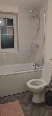 a white bathroom with a toilet and a shower at Modern One Bedroom Flat near Anfield Stadium with Parking in Liverpool