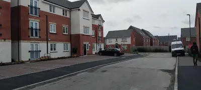 a car parked on the side of a street with houses at Modern One Bedroom Flat near Anfield Stadium with Parking in Liverpool