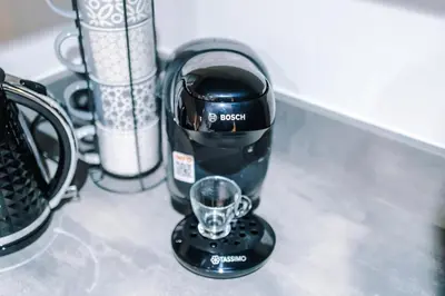 a black coffee maker sitting on top of a counter at Prestige Point Stylish City Apartment In Liverpool in Liverpool