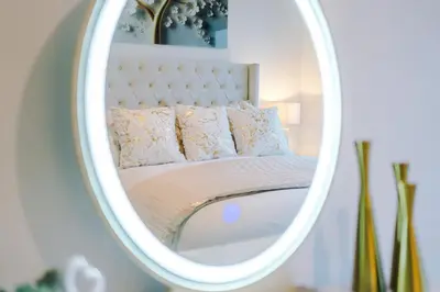 a bedroom with a bed in a mirror at Prestige Point Stylish City Apartment In Liverpool in Liverpool