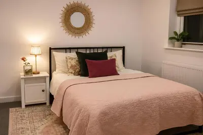 a bedroom with a bed and a mirror on the wall at Near Stadium - Free Parking - Sleeps 4 in Liverpool