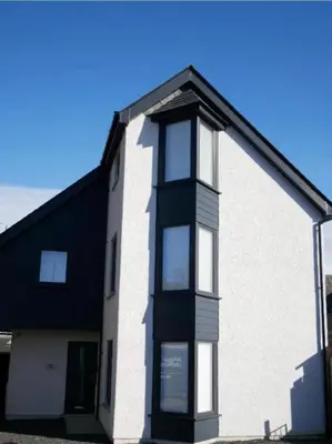 a white building with a black roof at The Barn in Courtyard in Ulverston