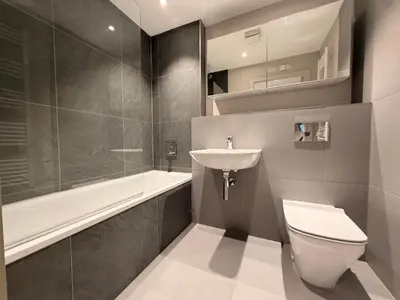 a bathroom with a toilet and a sink and a bath tub at The Barn in Courtyard in Ulverston