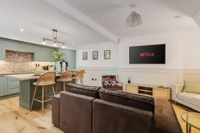 a living room with a couch and a kitchen at Dee Street Retreat - A coastal escape in St Annes in Lytham St Annes