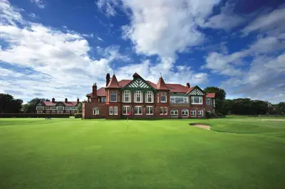 a large red brick building with a green yard at Dee Street Retreat - A coastal escape in St Annes in Lytham St Annes