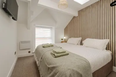 a bedroom with a bed with two towels on it at Dee Street Retreat - A coastal escape in St Annes in Lytham St Annes