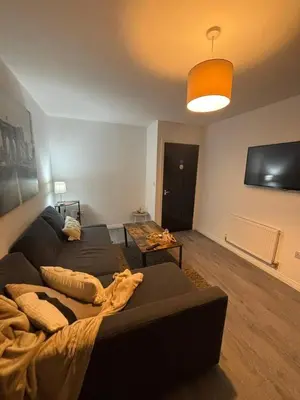 a living room with a couch and a table at Cozy 3-BR | Home in Merseyside | Free Parking in Bidston