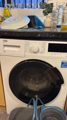 a washing machine in a kitchen with a counter at Cozy 3-BR | Home in Merseyside | Free Parking in Bidston