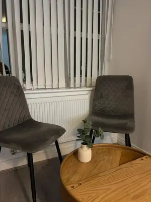 two chairs and a table in front of a window at Cozy 3-BR | Home in Merseyside | Free Parking in Bidston