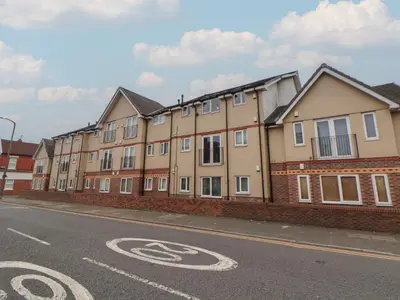 a row of houses on the side of a street at Flat 12 in Wallasey