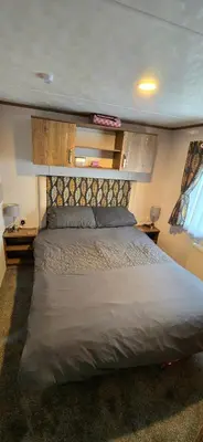 a bedroom with a large bed in a room at CJ's Happy Place in Heysham