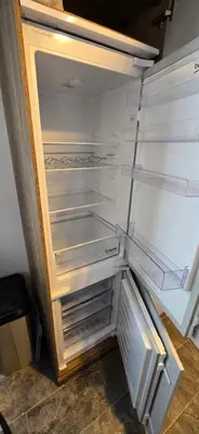 an empty refrigerator with its door open in a room at CJ's Happy Place in Heysham