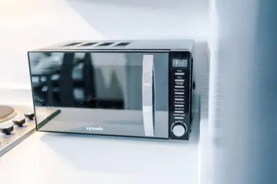 a microwave oven sitting on top of a counter at 3-BR Home in Wigan | Free Wi-Fi | Comfortable Stay in Ince-in-Makerfield