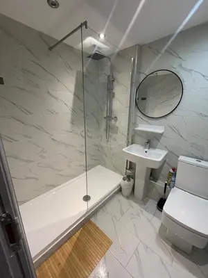 a bathroom with a shower and a toilet and a sink at Cosy Georgian Quarter Apartment - Sleeps 4 in Liverpool