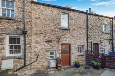 a stone house with a red door and windows at 2 Bed in Lindale oc-c34128 in Lindale