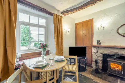 a dining room with a table and a fireplace at 2 Bed in Lindale oc-c34128 in Lindale
