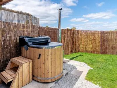 a wooden trash can sitting next to a fence at Harans Vardo - Uk42959 in Altham