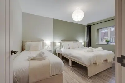 two beds sitting next to each other in a bedroom at Beach Stays - Ground Floor 2 Bed Apartment - Free Parking in Cleveleys