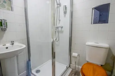 a bathroom with a shower and a toilet and a sink at Blackpool Retreat Group Stays in Blackpool