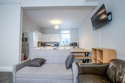 a living room with a couch and a table at Blackpool Retreat Group Stays in Blackpool