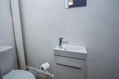 a white bathroom with a sink and a toilet at Blackpool Retreat Group Stays in Blackpool