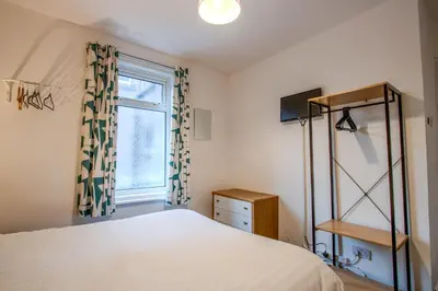a bedroom with a bed and a window at Blackpool Retreat Group Stays in Blackpool