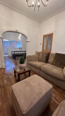 a living room with a couch and a table at Liverpool Maple House 3Bed - Walk to Anfield stadium in Liverpool