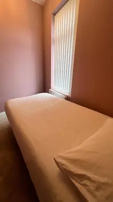 a bed in a room with a window at Liverpool Maple House 3Bed - Walk to Anfield stadium in Liverpool